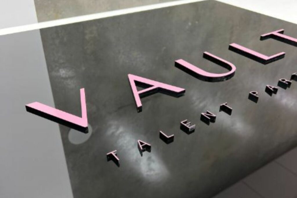 acrylic business signage australia with raised lettering on black gloss panel